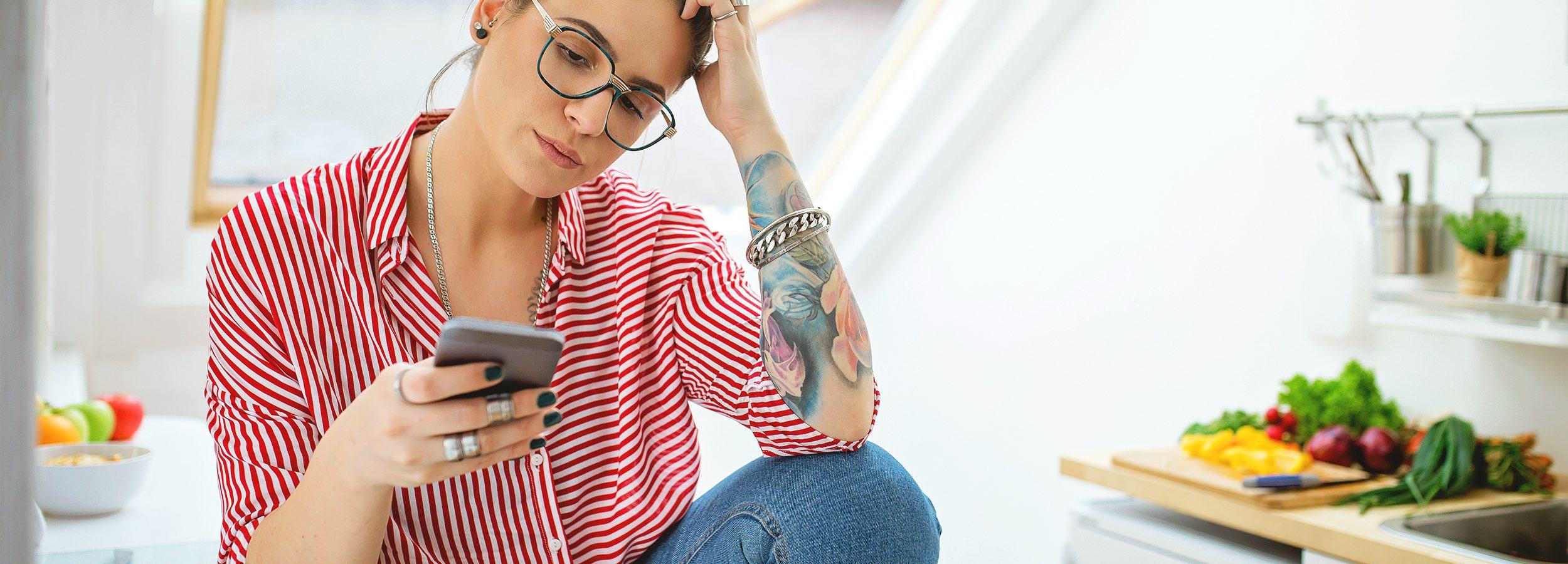 The truth about boundaries. Image of woman concentrating while looking at her phone.