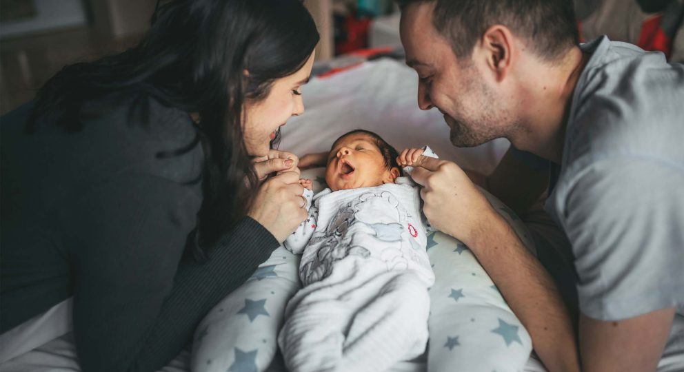 Picture of new parents with baby