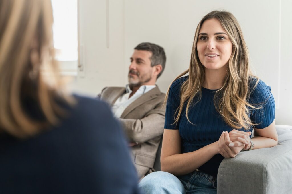 Therapy Dynamics: Smiling Wife Engages, Resentful Husband Retreats