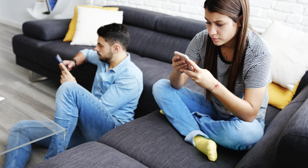 Couple turning to screens instead of each other