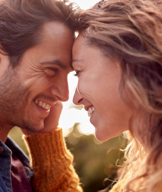 Portrait Of Happy Loving Couple Head To Head Outdoors