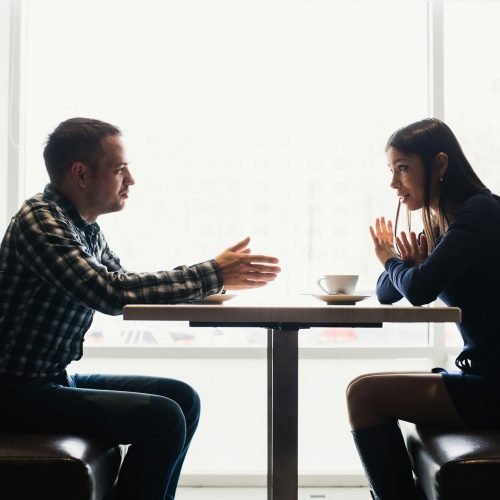 Scene in cafe - couple conflict arguing during the lunch.